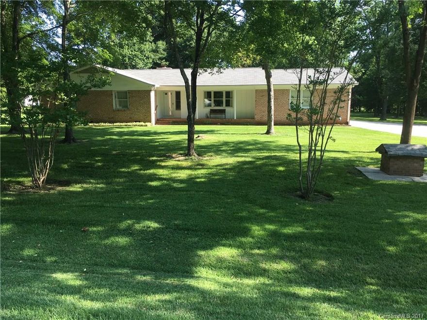 Do some rocking on the front porch or enjoy a very nice sun room with access to a wrap around deck. 1.29 +/-  Acre lot with trees and nice lawn. 2 car garage with work areas. 3 bed rooms 2 baths Den/ fireplace, Kitchen with Range, Refrigerator, nice cabinets .Dining area and living room.Also remaining for the buyer a  front load washer and dryer. Gutter Guardian installed 2008,Roof covering replaced 2008 ,Heat Pump installed 2008. Near Schools, Shopping, Hwy 29,49 & I-85