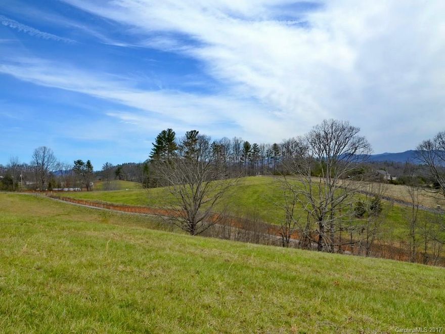SPECTACULAR views surround this beautiful lot, just 7 easy minutes from Weaverville's main street & 15 miles from downtown Asheville. Unbelievable year round long range views that will take your breath away in this upscale community. Build your dream home!