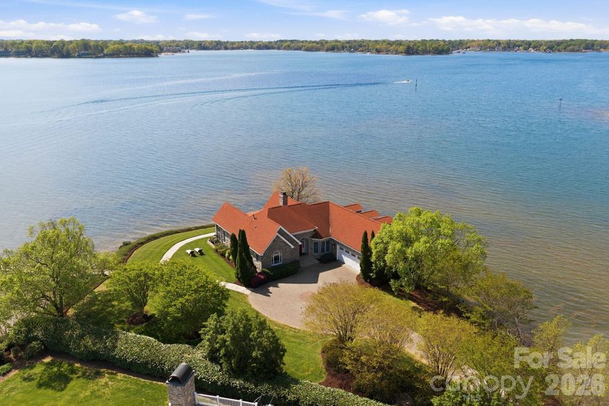 This property could be a set in a Nicholas Sparks or Nancy Meyers rom-com. The most charming stone clad home nestled on 720 feet of waterfront on the desirable Langtree peninsula. Minutes to all the shopping and dining at Birkdale Village. Renovated to the studs in 2015, the interior is as special as the exterior. Every room is full of light and astonishing water views. Vaulted tongue & groove ceilings with custom beams, island seating, marble counters. Spacious screened porch & deck. Dock w/ composite decking can accommodate 4 boats. HOA amenities offer pool, tennis/pickleball courts, boat ramp & storage. Present owners added HVAC to the garage and created a bunkroom. Nothing required to use as a garage again--this space is not included in the heated living area listed. This property is one of the most unique and charming properties on Lake Norman. Some furniture may be available for purchase.