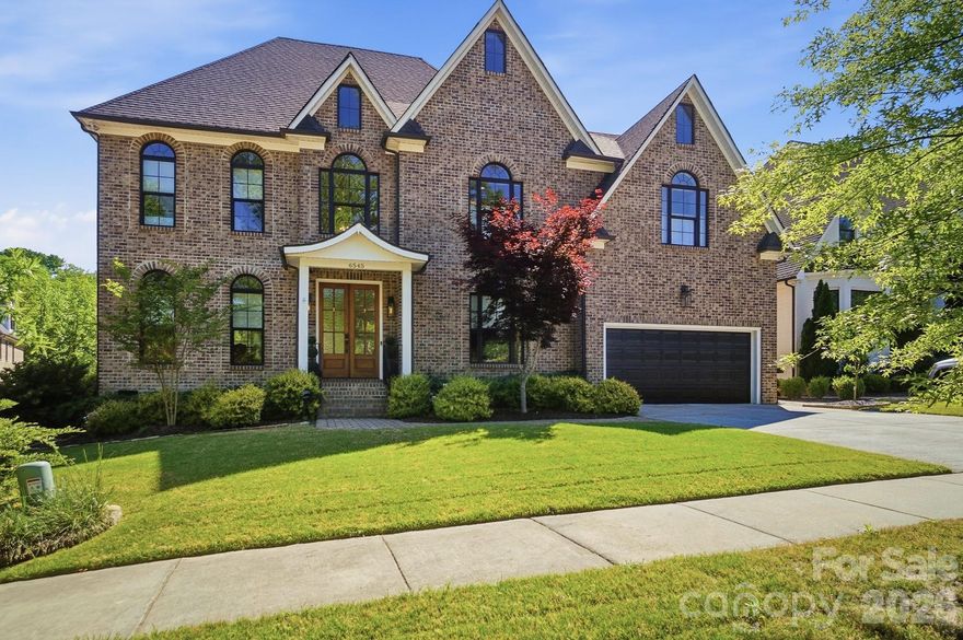 Stunning custom-built all-brick home in highly desirable South Charlotte, zoned for top-rated schools.  This showstopper features designer finishes and hardwood flooring throughout.  The inviting Great Room showcases coffered ceilings, custom built-ins, and a gas fireplace-perfect for both everyday living and entertaining.  The chef's kitchen is a dream with custom cabinetry, quartz countertops, dual ovens, and a gas cooktop.  Spacious secondary bedrooms, versatile flex space, and an expansive third-floor bedroom/bonus room offer incredible flexibility for any lifestyle.  Enjoy year-round outdoor living on the screened porch with its own cozy fireplace-ideal for relaxing or hosting.  Conveniently located just minutes from shopping, dining, Southpark, and Matthews, with an easy commute to Uptown-yet quietly tucked away in an exclusive enclave of custom homes. Refrigerator, washer and dryer to remain.