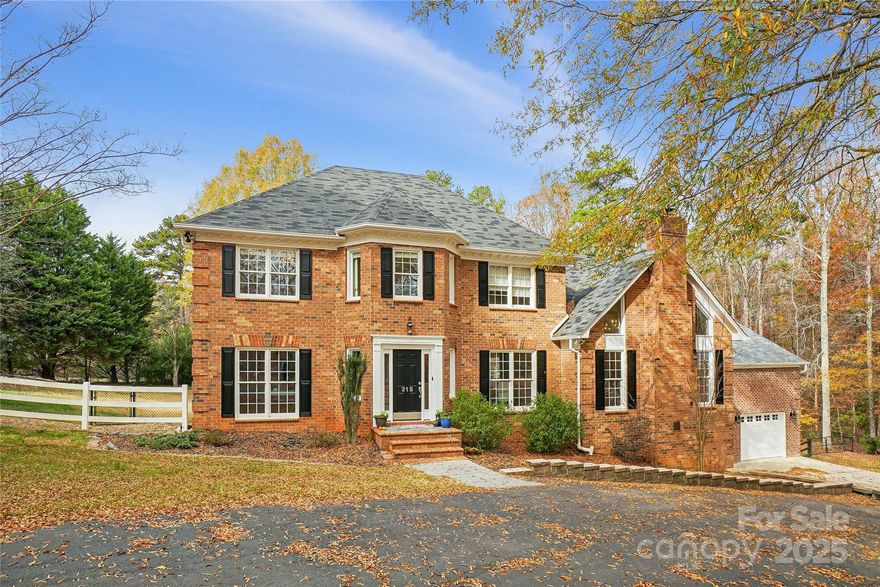Union county taxes! Weddington School district and NO HOA!!! Step into timeless Southern elegance at 315 Red Barn Trail, a Georgian-style estate gracefully nestled on over 3 acres of pristine countryside within the lovely Red Barn Trail community. Every inch of this custom home was designed to blend refined architectural tradition with modern comfort and livability, creating a sanctuary where peace and sophistication meet. Feel as if you live in the country yet minutes from south Charlotte and Waverly Shoppng center.

From the moment you arrive, the stately brick façade, circular drive, and mature trees set the tone for what’s to come. Inside, a flowing open-concept main level invites connection and entertainment, featuring a chef’s kitchen with granite countertops, expansive island, and a divine walk-in pantry. The great room’s vaulted ceilings and library with rich custom built-ins offer elegant spaces for relaxation or productivity, while the formal dining room lends itself to memorable gatherings.

Fully inspected with all minor repair items addressed and move in ready. Now priced below appraised value. Don't miss this opportunity. You'll LOVE it! 

The luxurious primary suite is a retreat of its own, boasting a spa-inspired bath and a custom boutique-style closetdesigned for effortless organization. Upstairs, four spacious bedrooms provide flexibility for family, guests, or home offices.

Enjoy dual living spaces perfect for multi-generational living — including a billiard room that flows seamlessly to a screened-in porch overlooking the sparkling saltwater pool and expansive grounds. The fully equipped lower-level apartment offers a private kitchen, living room, workshop, office, and direct pool access—ideal for guests, in-laws, or rental potential.

Outdoors, equestrian enthusiasts will fall in love with the three-stall horse barn (sold as is), fenced pastures, and ample open space for riding or expansion. Additional highlights include a three-car garage, workshop, and no restrictions, allowing freedom to create your ideal lifestyle and space with this property.

All this tranquility lies just minutes from Charlotte’s Waverly and Rea Farms shopping, dining, and medical centers, giving you the best of both worlds—luxurious country living with city convenience.

Welcome home to 315 Red Barn Trail — a rare legacy property where classic charm, privacy, and possibility abound.