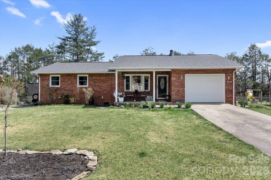 This updated single-level home with beautiful addition of primary suite and den, covered back porch and fenced back yard, offers 3 bedrooms and 2 full baths in a convenient Brevard location close to the hike/bike path. The kitchen features granite countertops, farmhouse sink, stainless appliances, and ample cabinetry, flowing into the dining area and main living spaces. The den,  with vaulted ceilings and abundant natural light,  provides additional flexibility and opens to a covered rear deck for easy indoor-outdoor living.

The primary suite includes a  bath with dual vanity, and a beautiful area with shower, and soaking tub surrounded by contemporary tile. Additional features include an attached garage, double drive ways, and a garden spot. Level yard offers usable outdoor space, ideal for a variety of needs. Connected to city water and sewer and located just minutes from downtown Brevard’s shopping, dining, and everyday conveniences.