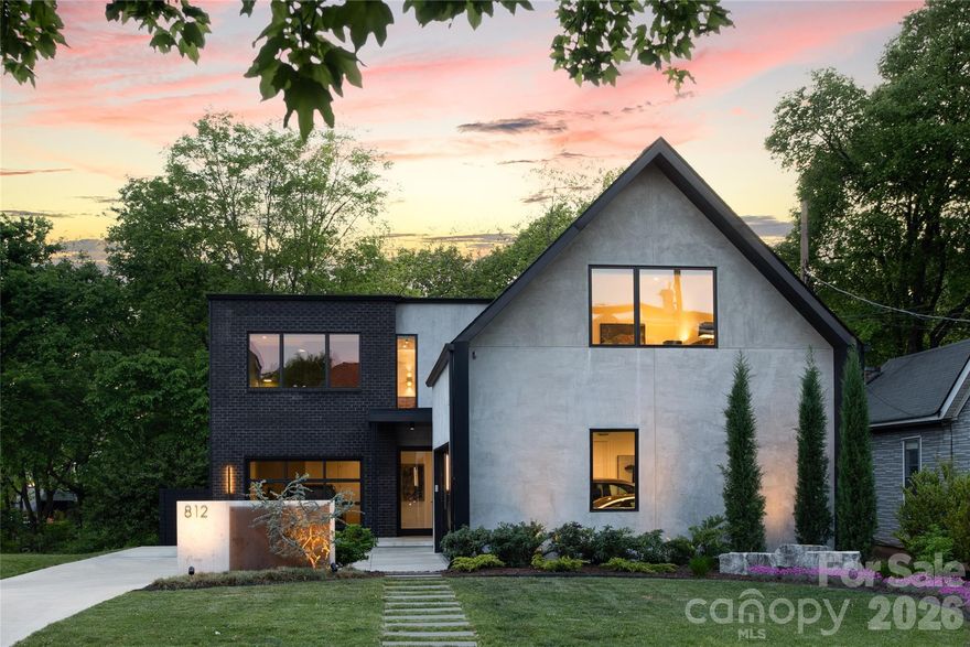 Striking modern residence located in Charlotte’s vibrant NoDa Artist District. Constructed in 2023 by renowned builder Peter Vasseur Homes and thoughtfully designed by Woodruff Architecture, this one-of-a-kind home was curated with design and art in mind, offering a sophisticated backdrop to showcase both everyday living and statement pieces.
Set on a generous lot, this 5-bedroom, 4-bath home seamlessly blends clean architectural lines with warm, organic materials. From the moment you enter, you’re met with a sense of intentional design, where wide plank white oak floors, polished concrete surfaces, and rich mahogany accents create a refined yet inviting atmosphere.
The open-concept living spaces are both functional and inspiring, anchored by a chef’s kitchen complete with custom cabinetry, a dedicated scullery, and thoughtfully integrated beverage stations. Expansive walls and carefully considered sightlines provide the perfect canvas for art, while large windows invite natural light to enhance every detail.
Each space throughout the home has been elevated with custom finishes, including designer lighting, a statement staircase, and tailored storage solutions. Modern conveniences such as smart home systems, spray foam insulation, and power blinds ensure comfort and efficiency without compromising style.
The three-car garage is equipped with EV charging in every bay, reflecting a forward-thinking approach to modern living.
Herrin Ave is more than a home, it is a curated experience where architecture, design, and lifestyle converge in one of Charlotte’s most dynamic and evolving neighborhoods.