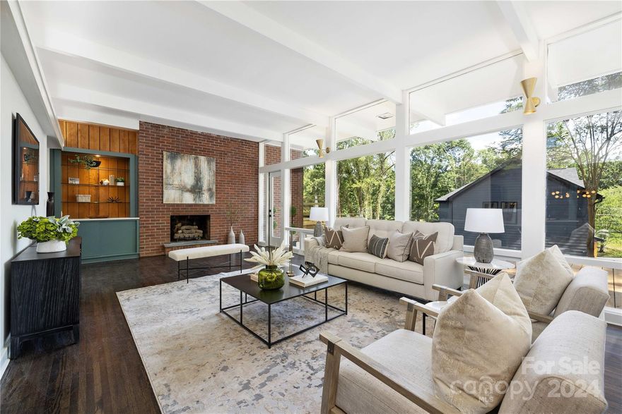 Stunning, bespoke MCM home by famed NC architect H. Cooler & featured on NC Modernist is now ready for a new owner. From the moment you step inside you will be wowed by the features of this generously sized 4BR/3BA home. Over 3100 sq ft, w/multiple living areas on the main floor, large windows create a light, bright and spacious living space surrounded by mature trees. Original Slate foyer and bonus space, hardwood and parquet flooring throughout. New LVP (2024) on basement level. Expansive new decks off main living area and each bedroom on the upper level. This is truly a one-of-a-kind property. Lower level includes additional BR/BA and living spaces with exterior access--could be an income property or perfect for multi-generational living. Most windows replaced (2024) New water and sewer lines (2024), Quartz counters (2024), kitchen & upstairs baths (2024). Lighting and plumbing (2024) Roof replaced approx. 5 years ago. Don't miss your chance to own a piece of NC history!