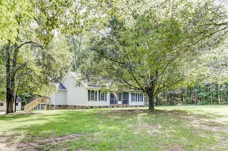 A little slice of heaven, short drive from I-77. Stunning 3 bedroom 2 bath home sitting on a very large corner lot, (1.56 Acres). Tons of privacy! Perfect starter home, retirement home – just waiting for a new owner. Home boast an open floor plan, wonderful layout.  Split bedroom floor plan, large family room w/fireplace open to the kitchen & eating area, screened front porch, large private back deck, storage building & additional wired storage building, man cave or perfect for weekend projects.