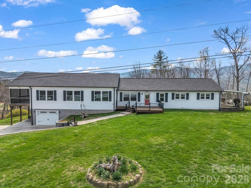 Unique opportunity in the scenic mountain town of Spruce Pine! 45 min. to Boone, an hour to Asheville, close to ski slopes and Blue Ridge Parkway. This versatile property offers exceptional flexibility and can easily be converted into a duplex or even a triplex, making it ideal for multigenerational living, short-term rental, or income-producing potential.  The main level is thoughtfully laid out with two separate living spaces. The left side features a private primary suite, kitchen, living room, laundry area, half bath, and a screened-in porch with hot tub, perfect for enjoying the mountain setting.  The right side includes two bedrooms, one full bath, a kitchen with breakfast area, dining room, living room, laundry, and a covered porch.  The basement level adds even more living space with a large bedroom and full bath, along with a garage and abundant storage.
In total, the home offers 4 bedrooms and 3.5 bathrooms.  Additional features include multiple septic tanks and tankless water heaters for added efficiency and convenience.  A new roof was installed in February 2025.  Outside, you’ll find a spacious 60x26 outbuilding with roll-up doors, ideal for storing ATVs, boats, or campers, or for use as a workshop.  Situated on 1.02 acres, the property showcases beautiful mountain views and provides endless possibilities for personal use or investment. Schedule your showing today!