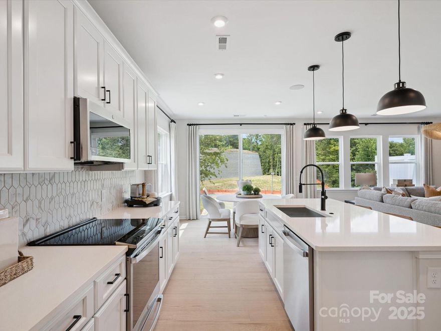 With 1,953 Square Feet, this Mayes plan is connected living at its best. Seamlessly connected from one room to the next, this home is perfectly equipped to be your new favorite place. Whether you're hosting family and friends around your kitchen island, or retreating to your primary suite, you'll fall in love with your new haven.
- End Unit at the end of the cul-de-sac with no neighbors behind and no buildings to the side.
-Connected, open concept kitchen with cream cabinetry contrasted by grey quartz countertops and glossy gray backsplash.
- Primary suite with en suite bath. Complete with walk-in shower outfitted with tile wall surround and floor pan. Complimented by large walk-in closet