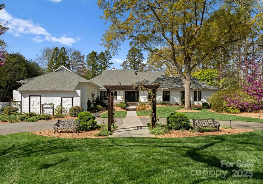 Mavenwood is a stunning 1.3-acre gated sanctuary w/ breathtaking gardens & an exquisite pool & spa. This exceptional 5,000 sq. ft. brick ranch offers 4 bedrooms, including 2 luxurious owner’s suites. Designed for comfort & entertaining, the home features a chef’s kitchen w/ premium appliances & custom cabinetry, plus a living area centered around a striking flagstone fireplace. An elegant living room w/ fireplace offers charm, while a 1st-floor office provides a perfect workspace. Floor-to-ceiling windows & high-end Clark Hall doors flood the interiors w/ natural light, seamlessly blending indoor & outdoor living. Upstairs, a 529 sq. ft. climate-controlled storage space lined w/ Eastern Red Cedar offers endless possibilities & could easily convert to a bonus room. Just moments from Charlotte Country Day & all that SouthPark offers, this estate balances luxury & seclusion. A true entertainer’s paradise, this home is an extraordinary retreat in Charlotte’s most coveted neighborhood.