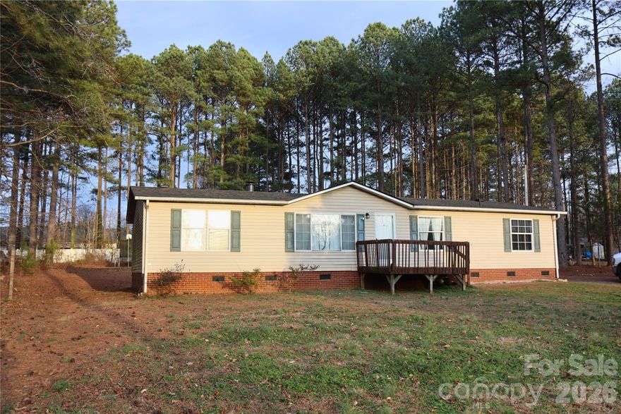 Welcome home! Discover the charm of modern living in this beautifully updated manufactured home nestled in a serene community that offers the perfect blend of comfort and convenience. This charming 3 bedroom 2 full bathroom home offers 1,512 sq. ft. of thoughtfully designed living space featuring a spacious open-concept living area, a well appointed kitchen with updated cabinets and a cozy dining space perfect for family and friends to gather. The owners suite has a remodeled bathroom, featuring a walk in shower and garden tub. Step outside onto your back deck where you can look out on almost an acre while enjoying the peace and fresh country air, or step out further and sit around your fire pit under the night sky. This backyard has ample room for a flower or vegetable garden, or a swimming pool. An oasis! Recent updates have been made to the owners bathroom, walk-in closet, Kitchen and front bathroom. Roof was replaced in 2025, septic was pumped in 2025, HVAC has been serviced, air ducts have been cleaned. Come and see what this home has to offer in person! Schedule with ShowingTime.