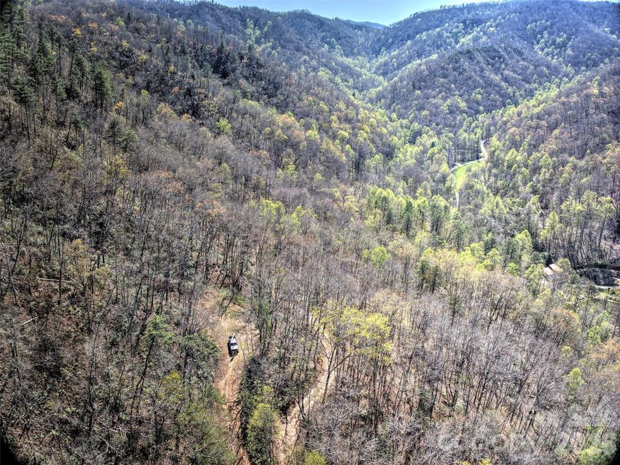 Nestled beside the Nantahala National Forest, this private subdivision offers unmatched beauty and versatility. With six distinct lots, the property provides diverse development options, including strong potential for rental homes catering to the area’s outdoor enthusiasts. The standout view-lot includes a prepared house pad, ready to bring your vision to life. Lot 3, with its prime location, is ready for expansion or new construction and offers breathtaking views down the Little Tennessee Valley. Conveniently located between Bryson City and Franklin, this subdivision sits at the Rattlesnake access point on the Little Tennessee River, a dream destination for fly fishing aficionados and paddlers alike. The entry road winds along a picturesque creek, featuring a small waterfall and captivating views, setting the tone for this remarkable retreat. Whether you’re planning a personal retreat or looking to capitalize on the growing demand for rental homes, this property is a rare find.