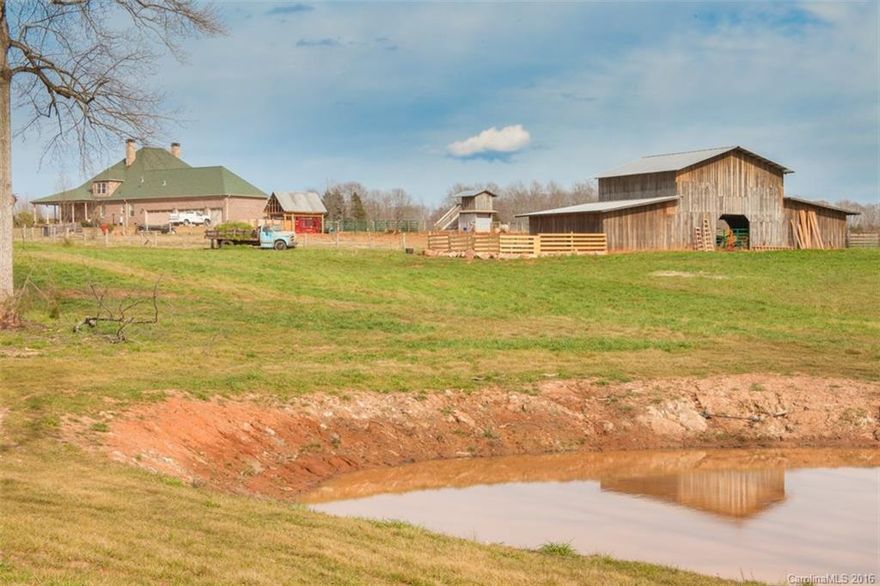 Magnificent custom built home on 16 plus acres! Upgrades at every turn-American walnut, travertine & granite floors, top of the line appliances, Wolf stove,  countertops, top of line throughout, judges panel, plantation shutters, 4 fireplaces, enormous open recreation area on upper level, wrap-around-porch, 5 car garage, granite. Bonus room plus Media/Gathering room w/2 fireplaces, 1 in Greatroom & master. 5 stall Pole barn. Bring your horses, cows, chickens, pigs!! Amazing POND!!!