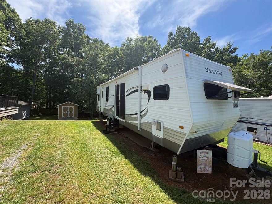 Welcome to Badin Shores Resort at Badin Lake—where the true value is in the LOT and the endless possibilities it offers! This spacious lot includes a well-maintained 2010 Salem Villa Estate camper. At this price, it’s almost like getting the camper FREE with the purchase of the lot!
Whether you want to enjoy the existing camper immediately, add a deck and outdoor entertaining space, upgrade to a park model, or even install a modular home in the future, this property provides the flexibility to create your ideal lake retreat. 
One of the standout features is the desirable “A” lot, offering additional usable space. The property extends just past the shed, providing extra room for expansion, entertaining, parking, storage, or future improvements. The large backyard area creates a peaceful setting with wooded privacy and room to truly enjoy the outdoors. 
The included shed offers excellent storage for lake toys, tools, golf cart accessories, and more. The lot is already set up and ready to enjoy with the camper in place, making it easy to start enjoying Lake Life right away while planning future upgrades over time. 
Inside the gated Badin Shores Resort community, owners enjoy an impressive list of amenities. 
Affordable opportunities with this much lot potential inside Badin Shores Resort are becoming harder to find—don’t miss your chance to secure your own slice of Lake Life at Badin Lake!