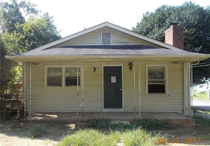 One story home with 3 large bedrooms and 1 full bathroom. Listed below tax value. All vinyl siding with a covered front porch. Needs updating.  The kitchen is large and has lots of cabinets and counter space. The lot is a level corner lot with a large back yard. Needs TLC.