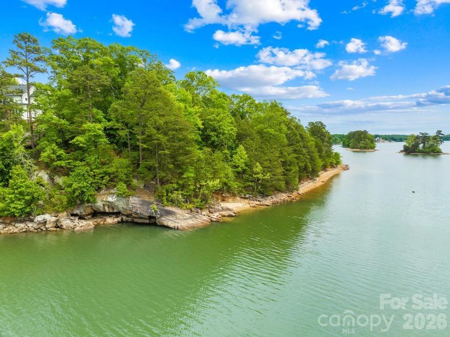 Discover an extraordinary opportunity to create an estate in the prestigious gated Harbor Watch community on Lake Norman. Positioned at the end of a quiet cul-de-sac, this exceptional .72-acre waterfront homesite offers approximately 174 feet of shoreline along the main channel, delivering expansive water views and an unmatched sense of privacy. The sloping topography is ideal for a walk-out basement design, allowing you to fully capture the beauty of the lake while seamlessly blending indoor and outdoor living. With no time limit to build, you have the freedom to bring your own builder and craft a custom home with no timeline. Based on a recent soil evaluation, Lots 27 and 28 (268 S Harbor Watch Dr.- MLS #4375882) are being marketed together to create a 3-4 bedroom estate, resulting in an impressive 1.53 acres and approximately 363 feet of shoreline- an almost unheard-of footprint on Lake Norman.   Surrounded by natural beauty and in one of the area’s most desirable gated communities, this property offers the perfect balance of seclusion, luxury, and lifestyle. Experience the serenity of waterfront living while remaining just moments from everything Lake Norman has to offer. Harbor Watch offers a boat storage lot, community boat launch and day docks, picnic area, and catch and release stocked ponds.
