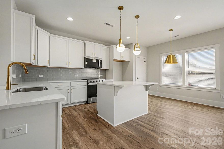 Stunning new construction townhome with 5 bedrooms and 3 full bathrooms, thoughtfully designed for today’s lifestyle. Enjoy the convenience of a main level bedroom and full bath, ideal for guests, multi-generational living, or a home office. The open living area showcases a cozy gas fireplace and custom lighting, creating a warm and inviting atmosphere. The kitchen is designed for both function and entertaining, complete with a breakfast bar pass through and a center island.  Upstairs, the expansive primary suite includes a walk-in closet and a luxurious ensuite bath with dual vanities, a separate shower, and a relaxing garden tub. Additional bedrooms provide ample space, while a one-car garage adds everyday convenience. Thoughtfully designed and move-in ready—this home blends comfort, style, and modern living.