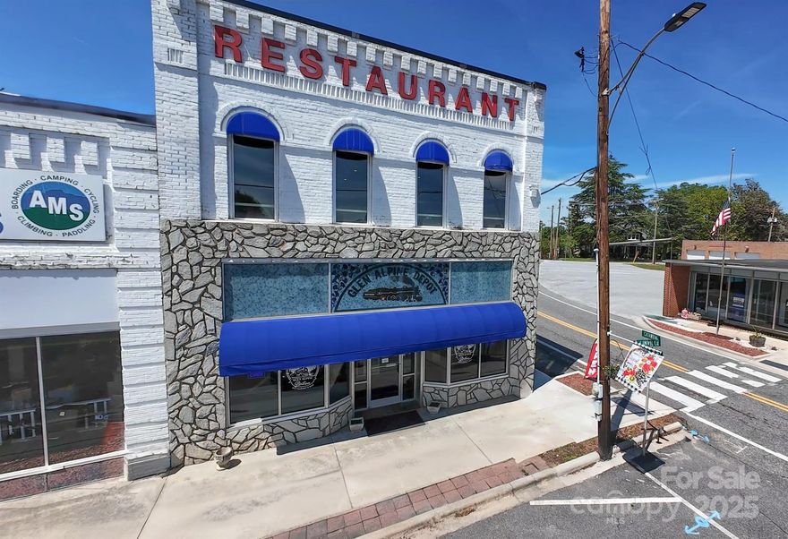 HUGE PRICE IMPROVEMENT! If you are looking to get into the restaurant industry or expand to a new location, check out this property. Located in the quaint town of Glen Alpine, this historic building is located at the corner of Catawba and Linville Streets and dates back to 1902. It is aptly named Glen Alpine Station as the train passes by the front doors on a daily basis. The current owner has recently updated the restaurant with a new roof in 2024, some new kitchen appliances and installed booths downstairs. An ornate wood staircase leads to the upstairs lounge area that has a full bar. The upstairs area showcases original hardwood floors that have been refurbished and beautifully arched windows with views over Main Street, as well as long range mountain views.