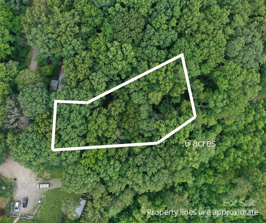 Located down a quiet private road, this gently sloped wooded lot in Woodfin is awaiting your vision! At over half an acre, with no HOA, easy access to electrical utilities nearby, and zoning that supports manufactured homes, the possibilities are wide open. Nestled among mature trees and native foliage, this serene property offers a peaceful setting above the floodplain and just a stone’s throw from the French Broad River. Situated between Asheville and Weaverville, enjoy the plethora of local dining, shopping, and other outdoor activities within a 20 minute drive. 15 minutes to UNC Asheville.
Expired 3 bedroom septic permit on file.