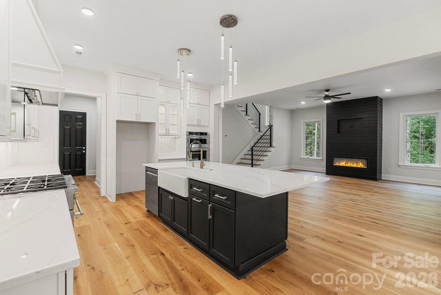 Tucked into an established neighborhood on a 1.26 acre cul-de-sac lot, this full-brick 2-story brand new custom home with basement is the perfect blend of comfort and elegance. The home has been thoughtfully sited on the lot to provide seasonal views of Lake Twitty from the front and wooded views to the rear of the lot from the back while creating usable flat yard space off the covered back patio. 

The attention to detail continues inside the home with gorgeous wide plank hardwood floors, 8' solid core doors, shiplap accent wall, and so much more. The chef's kitchen features a 4'x8.3' island with bar seating, 36" gas range, wall oven and ample cabinet and counter space all while remaining open to the dining area and generous family room which opens to an incredible covered porch. The main level primary suite is a spa-like retreat with custom cabinets, walk-in shower with frameless surround, stand alone tub and a walk-in closet with custom shelving. Also on the main level, a beautiful office, powder room, walk-in pantry and laundry room with plenty of storage.

Upstairs, two bedrooms, each with walk-in closet, share a jack and jill bath -- also with custom cabinets and full-tile shower with frameless surround. The wide plank hardwoods from downstairs continue upstairs everywhere except for the bathroom. A generous loft provides additional space on the 2nd level for whatever you need -- play room, den, home gym, 2nd office?

In the basement, entertaining will be king. Two huge, separate spaces - one with cabinets and a wet bar -- game room? media room? -- AND a bedroom and a full bath -- basement apartment for multi-generational living? -- truly endless possibilities.

Three HVAC systems ensure comfort on every level. Anderson casement windows. Oversized two car garage has an 18'x8' garage door with side mount motor. City water and sewer. 

With 4 bedrooms, 3.5 baths and over 4700 heated square feet, this brand new custom home is ready for you to call it home.