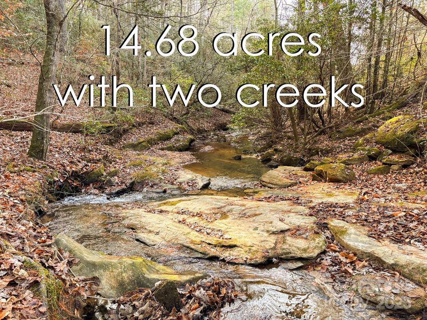 14.68 Acres of wooded oasis in Western NC!! Enjoy acres of unrestricted land with two creeks! Perfect for a private estate or subdevelopment opportunity. Zoned R-3, will allow duplexes. Convenient location near Hwys 70, 321, and I-40! Accessible from two publicly maintained roads and offering city water and sewer. Land has city easement/driveway maintained by city for sewer line maintenance.