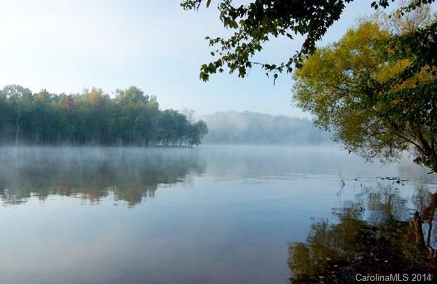 Dock permit approved. Transfers to new owner. Deep water cove views close to Windjammer Park recreation area with swimming beaches and almost 360 degree lake views, and picnic pavilion. The cove has a peninsula and the house would be built with a magnificent view of that cove and the back bay behind Windjammer point. Lot is more level next to the water where the house would be built with panoramic views.  Spectacular location in Tega Cay.