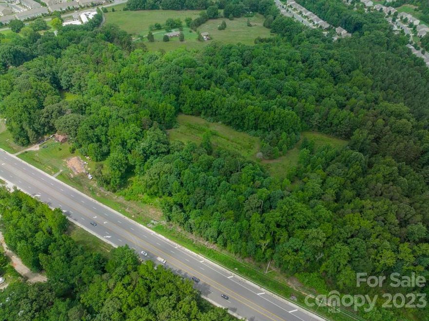 This amazing 10.42 +/- acre opportunity has been created in Fort Mill SC just 0.2 miles to the NC state line. This beautiful land is primed to be developed. The current zoning is RUD. York County Planning has indicated mixed use could potentially be approved. Any change in zoning would have to be approved by York County Zoning and Council.  There are 5 parcels making up the 10.42 acres. #648-00-00-009, #648-00-00-0026, #6480000010,#6480000030, #6480000022. Fort Mill is a community rich in culture and history. This area is ready with opportunity!