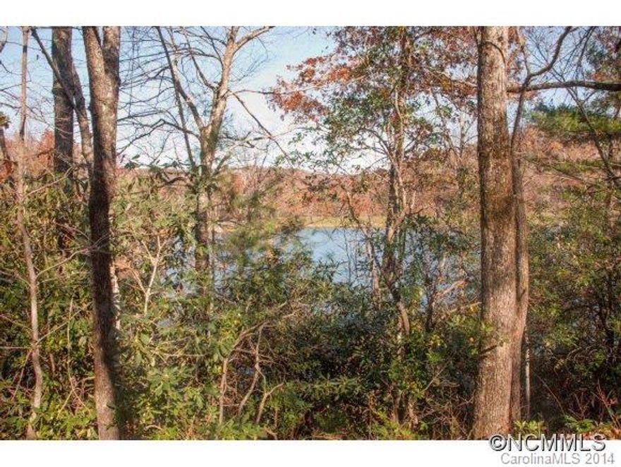 Beautiful double combined lot on Lake Ticoa. Lot is set on a lovely bay.  The lake is stocked with trout and bass. Catch your supper in your back yard. Connestee Falls is a gorgeous mountain community of approximately 3900 acres. Priced $101,000 below assessed value.  Golf course, swimming pool, tennis facility, wellness center, parks, hiking trails, clubhouse, bocce court, pickle ball, approx. 60 clubs.
