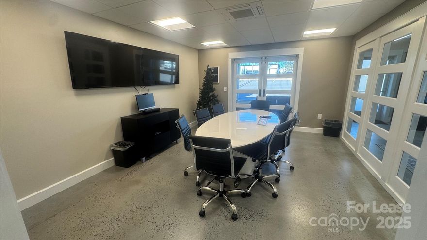 Move-in-ready commercial suite with a clean, modern buildout and a flexible layout that works equally well for office, studio, showroom, or light creative/flex operations. The space features a large open work area with polished concrete floors and an exposed, painted ceiling with bright linear lighting—ideal for collaborative teams, production tables, or configurable workstations.

A dedicated conference room with glass doors and built-in A/V creates a professional client-facing environment, complemented by a lounge/break area. The suite also includes a well-appointed kitchenette with butcher-block counters, open shelving, stainless sink, and coffee/bar setup.

Ideal for: design/build firms, architects, engineers, marketing/creative agencies, e-commerce ops, product/showroom space, consulting teams, or any business needing a mix of open workspace + client meeting capability.  Lease terms are flexible.  Available immediately.