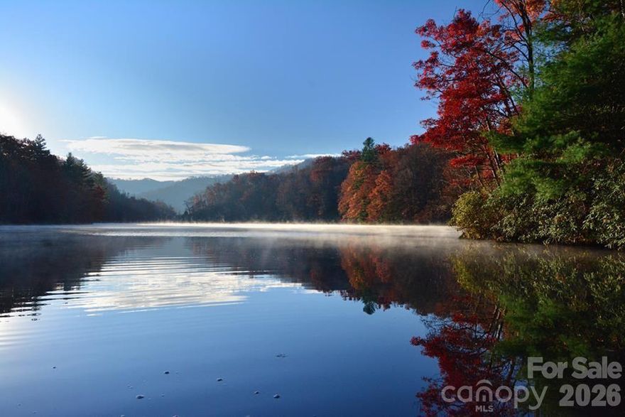 PRICED TO SELL!!! Build your mountain lake home on this beautiful lot at Cedar Cliff Lake. This property is located near the end of the lake where the water is deep, and the lake is wide. Duke Energy owns the shore line around this lake and has given the owner verbal permission to build the trail from the lot down to the lake and to build the boat dock which is larger and grandfathered in to accommodate motorboats. Cedar Shores common area includes a boat rack and a 4 slip marina. Cedar Cliff Lake is also considered the best lake around to paddle on. A paved road leads to Lot 5's gravel/grassy driveway. Just 12 minutes to WCU and a short distance further is Ingles, CVS, Lowes, restaurants, schools and Sylva. If you head south, Cashiers is 17 miles away.  Enjoy all the mountain adventures around - Bryson City, Cherokee, Waynesville and Asheville.