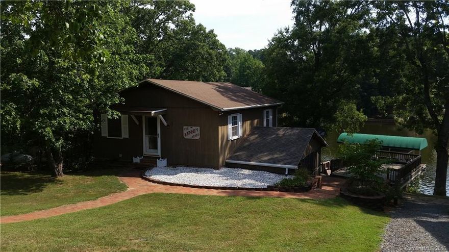 This neat & clean 2 level waterfront home is located in a quiet cove on Badin Lake. Floating pier, with covered boat slip, & an on ground boathouse with upper sundeck. The lower level features a kitchen & living area, with stylish spiral stairs leading to the upper level bedrooms. Master suite overlooks the lake & features a spacious bathroom with jetted garden tub. Off the living room is a peaceful screened porch. Lakeside deck, & patio. Storage building w/carport.  Significantly Remodeled 2010