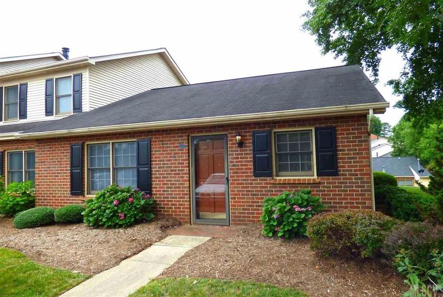 End-unit, one-level townhouse in Colony Square offers ease of access with no stairs to climb! Features include an open living room/dining room combo with wood-burning fireplace and exit to the rear sunroom. Cute kitchen with all appliances. Two bedrooms share a hall bath. Extras include all wood floors with tile in the bathroom. Quiet location at the back of the complex. Water heater replaced 2014. HOA Dues: $115/month.