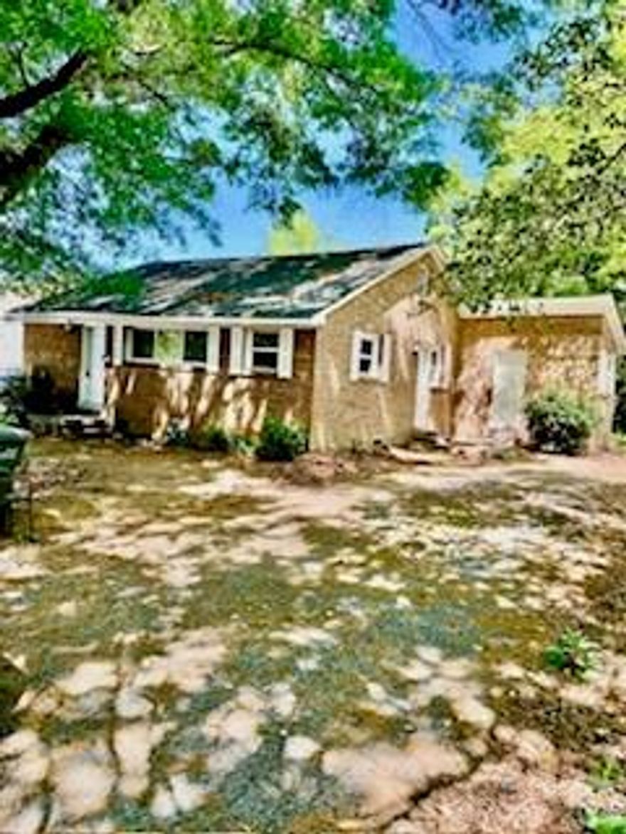 This cute little bungalow ranch home sits back behind a home in a private setting. Upon arriving, turn down driveway which is a shared driveway and drive past the home facing E. Green.  This homes sits behind the one facing E. Green.  Completely private setting for a buyer.   Over the years has been updated. Selling home 'as is' and owners has never occupied the home.  It has newer cabinets, newer tub/shower combination; although needs a little love.  More recent HVAC unit, and water heater.  Full brick and could be a quaint little hideaway if you like your own privacy.  When facing the home the lockbox is located on the front door.  Make appointments through showingtime.