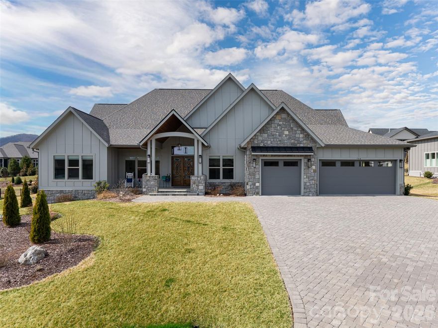 Come experience this easy one-level living home in the gated upscale community of Mills River Crossing. Step inside to high ceilings and a soaring natural limestone fireplace that anchors the spacious great room. The open-concept layout flows seamlessly into the chef's kitchen, where quartz countertops, premium KitchenAid appliances, and a generous waterfall island create the perfect setting for both entertaining and daily living. Retreat to the spacious office or bonus flex room for some alone time to relax, study or work out. The primary suite offers a spa-like retreat with dual vanities, a large double-entrance shower, and a deep soaking tub designed for ultimate relaxation. Outdoor living is just as impressive with a fully screened, stone-tiled patio featuring a natural stone fireplace and built-in grill, which creates an inviting space to relax or host gatherings year-round. Additional upgrades include a large fully fenced backyard, enhanced landscaping, epoxy garage floors, EV charger, paver driveway, in-ground irrigation system, and an encapsulated walk-in crawlspace providing generous storage. An extended concrete patio (currently set up as a basketball court) offers the flexibility to remain as is or be transformed into additional outdoor living space. Custom remote blinds in all bedrooms and a central vacuum system add convenience and comfort throughout. Experience community events at the park, which includes a picnic pavilion with outdoor fireplace, grill and firepit, fenced dog park, walking trail and playground. Don't miss the opportunity to experience this peaceful, private, gated community.