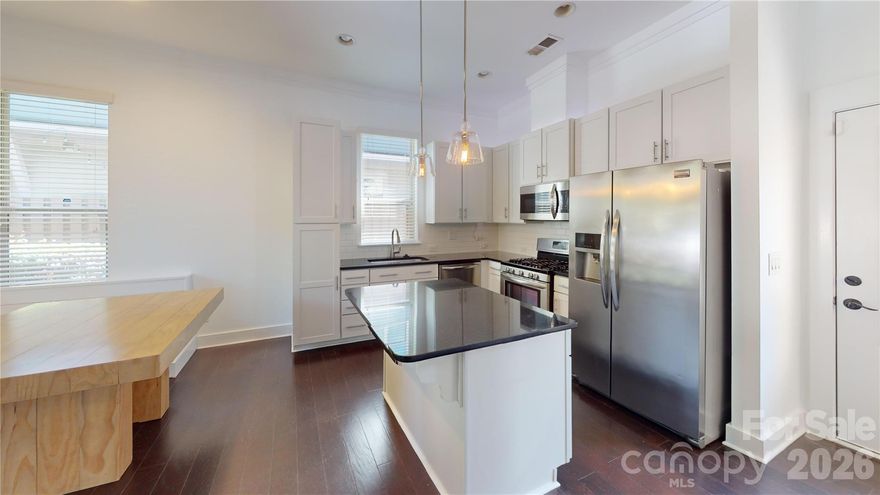 Owner just had the entire unit painted and new carpet installed upstairs, so this is move in ready!!!  Live close to all the action in NODA in this beautiful 3 bedroom, 2 1/2 bath end unit with covered front porch and balcony off of owner's suite.   Hardwood floors, kitchen island, granite countertops, gas range and more in this stunning unit.  Fenced in courtyard with extra storage.  Washer and dryer included.
