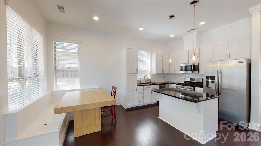 Live close to all the action in NODA in this beautiful 3 bedroom, 2 1/2 bath end unit with covered front porch and balcony off of owner's suite.   Hardwood floors, kitchen island, granite countertops, gas range and more in this stunning unit.  Fenced in courtyard with extra storage.  Washer and dryer included.