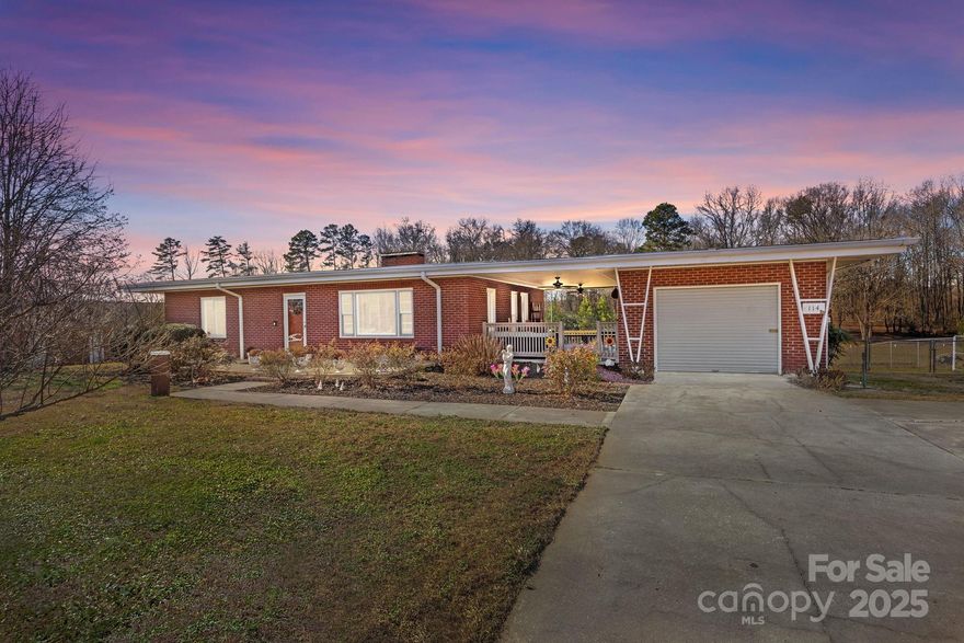 Discover mid-century modern charm at 114 Valley Drive in the golf-cart-friendly town of Badin. This 2-bed, 2-bath home features granite countertops, LVP flooring, smart thermostat, updated 200-amp service, and a Tier 2 EV charger. Enjoy a spacious full basement with HVAC & an additional 1194 square feet (not included in heated living area) that’s perfect for entertaining, office, hobby room, or storage, plus a cozy woodstove. Relax outdoors under the large covered breezeway and enjoy the fenced-in backyard. Property also includes an attached one-car garage and a 20x20 outbuilding with two garage doors. City water and sewer are in place. Conveniently located just minutes from Badin Lake and Morrow Mountain State Park—experience small-town living with quick access to outdoor recreation.