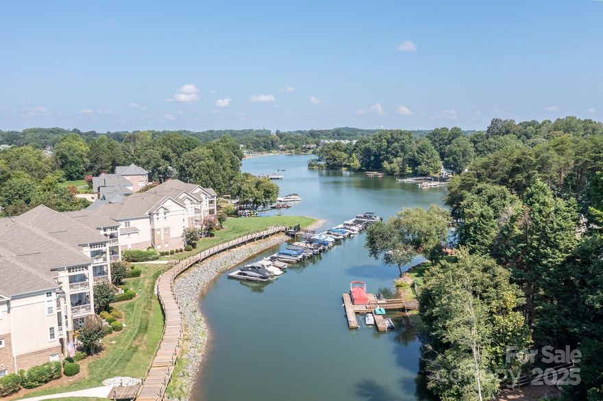 Freshly painted interior!  ALL walls, doors, and baseboards painted including closets.  Ready for a fresh start. This WATERFRONT unit on Lake Norman is priced to sell! 2nd-level unit with 2 beds and 2 baths and year round water view. Wide plank LVP in main living spaces and hall. Quartz counters in both baths. HVAC replaced in 2024. The shower in front bathroom was rebuilt/replumbed in 2023. The building's roof was replaced in January 2023. The community amenities include a boardwalk allow you to easily access the lake and pool/tennis areas. Boardwalk is being replaced with composite decking by HOA in stages.  Stage 1 complete. HOA fees include lawn care, water/sewer, cable, and recycling/trash. Enjoy a dip in the pool while grilling out at the clubhouse. You can also enjoy a late-night stroll on the lighted Boardwalk. Located just off exit 33 of I77, close to Lowe's Corporate, Langtree shopping and restaurants, waterfront restaurants across the cove, shopping, and more.