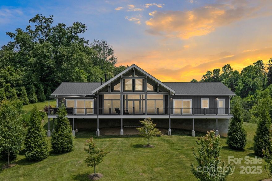 Experience refined mountain living in this flawlessly constructed luxury home. 2893 sq ft of one-level living on 6  unrestricted acres w/ multiple additional home sites. Built w/ spray foam insulation throughout, the home features 3 bedrooms and 3 full baths on the main floor with no interior thresholds. The open-concept layout is enhanced by floor-to-ceiling windows and high-end finishes, including a luxury Thermador kitchen appliance package. Expansive covered outdoor living spaces and multiple decks provide the perfect backdrop for relaxing or entertaining. The meticulously maintained grounds feature a vineyard, fruit trees, & lush landscaping. 2100 sq ft of unfinished basement space with 10’ ceilings & a 1/2 bath offers endless potential. A detached 2000 sq ft garage/shop includes a full bath and 12’ drive-through doors—perfect for RV storage or a workshop. Multiple other home sites for generational living. A rare and exceptional estate built for comfort, elegance, and versatility.