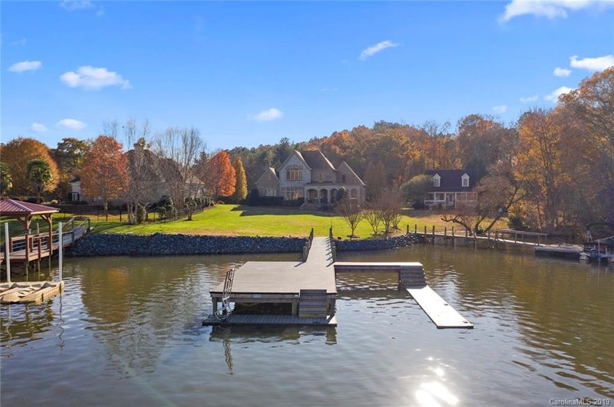 Amazing Lake Wylie waterfront home with big lake views! This level 1 acre lot is located on Big Allison Creek. The area of the lake is perfect for boating, watersports, fishing, and hunting. Entertain your friends or just take a moment for yourself on the covered porch overlooking the lake. The open floorplan and huge windows allow for the natural light to illuminate the home. Owners suite is located on the 1st floor with two additional bedrooms upstairs. Pamper yourself in a well-appointed master bath with a walk-in shower, spa, tub, and dual vanities. Head upstairs where you will find another gorgeous view of Lake Wylie from the media center/ bonus room. Two bedrooms and an additional bathroom and plenty of attic storage. Moor your pontoon boat or ski boat to a composite topped stationary dock or, throw your line in the water a see what bites. This home has low SC taxes and is in the award-winning Clover school district.  Minutes from shopping and Restaurants. See you at the Lake.