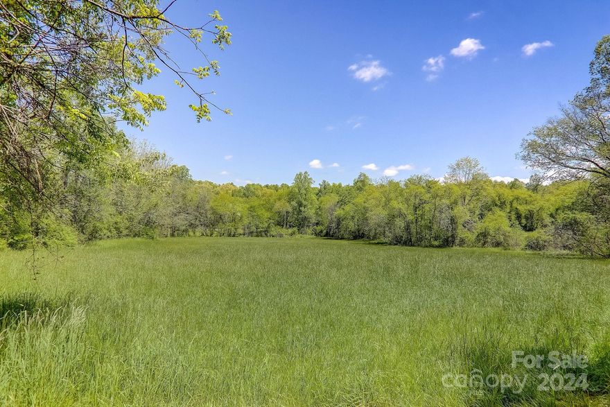 22.2+/- Acres in the Hoopers Creek Area of Fletcher. Conveniently located between Asheville & Hendersonville and 14 mins to the Asheville Airport. This rare property offers 10+/- acres of cleared pastures perfect for a Horse Farm. Paved, state road for access. A beautiful & versatile property that sets up nicely for a private estate, family compound or a small community. Shopping, Restaurants, Schools, and other the other necessities are nearby.  No Restrictions and is Zoned R2R.