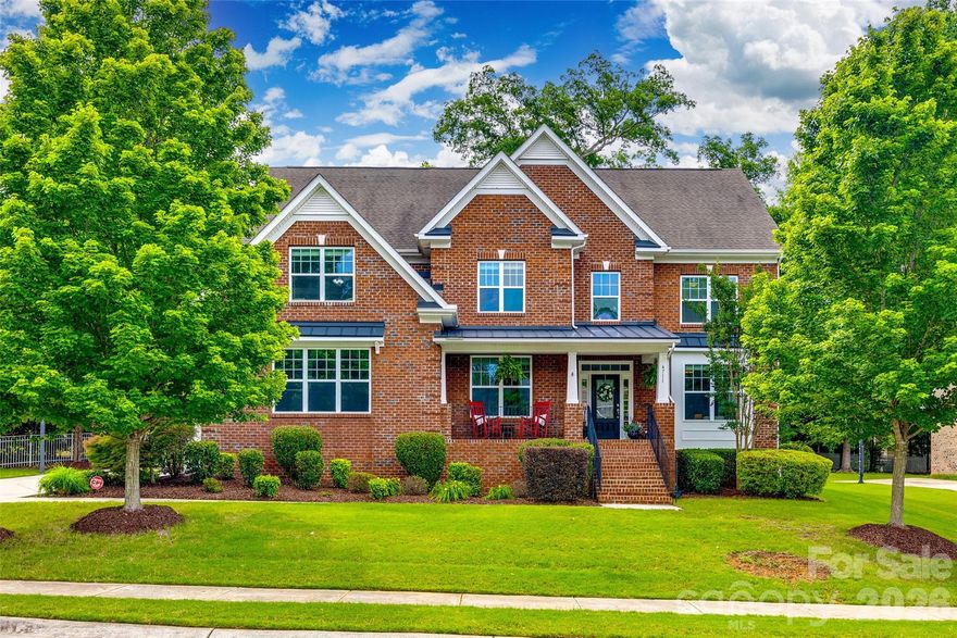 Beautiful full brick 3-story home in sought after Lawson! Spectacular Harrison floorplan features 6 BRs, 4.5 baths-PLUS 3rd floor bonus/rec room!  Beautiful hardwood floors downstairs and in upstairs hallways. Gourmet kitchen w/granite countertops, dbl ovens, gas cooktop, SS appliances, and custom pantry! Formal living and dining rooms, office w/ French doors and large family room w/ fireplace. Front & rear stairs lead to to 2nd level. Primary suite w/sitting area, bathroom w/garden tub & large glass shower and custom closet. Three additional BRs + bonus/6th BR. Second floor bedrooms share 2 Jack & Jill baths. Stairs to large 3rd floor game/rec room + BR w/full bath! Deck overlooks serene fenced rear yard with perennials galore, a built in gas grill and gas fire pit w/seating area! 3-car garage & rocking chair front porch too!  Lawson has resort-style amenities that include a clubhouse, 2 pools, fitness centers, walking trails, playgrounds & tennis/pickleball.