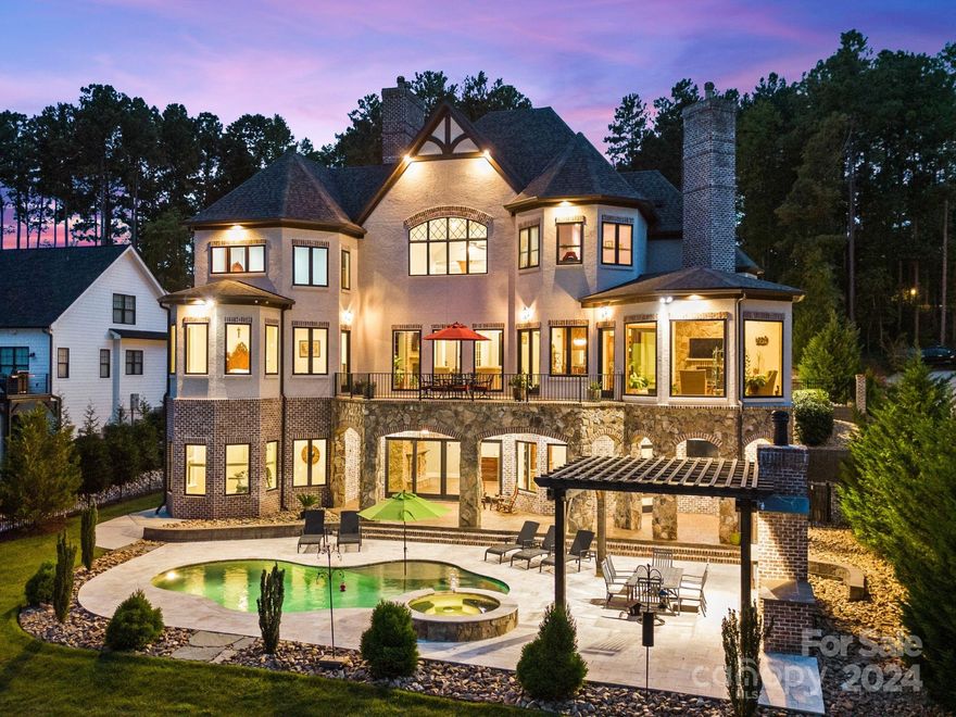 Escape to your own private oasis in this stunning luxury waterfront home located on the picturesque shores of Lake Norman. Enter through double iron-clad doors to a grand two story foyer and great room with floor-to-ceiling windows offering an abundance of natural light. The gourmet kitchen offers top of the line appliances, custom cabinetry and a large island, perfect for entertaining. The primary suite is conveniently located on the main level where you will find a luxurious bathroom with an oversized shower, soaking tub, and walk in closet. The outdoor living area is just as impressive as the interior, with an oversized patio that is perfect for relaxing & an oversized pool deck, ideal for soaking up the North Carolina sun and blue skies. The backyard leads to your private dock, making it easy to enjoy all the water activities that Lake Norman has to offer. The highly sought after location makes travel a breeze & is close to restaurants, shops & everything else Denver has to offer!