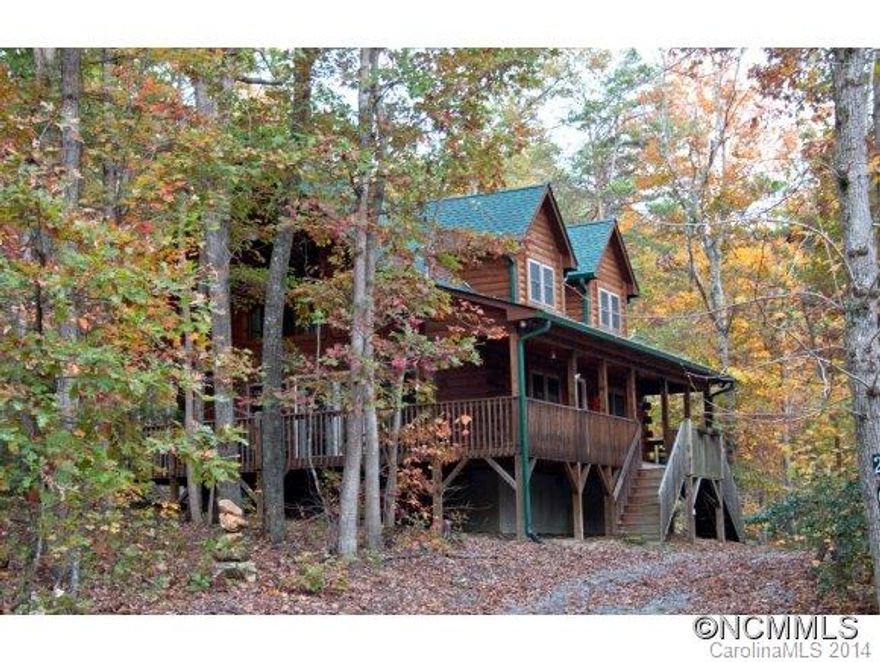 SEE VISUAL TOUR! This IMMACULATE 2BR, 2BA Log Home is located on a wooded .9 acre paradise in the gated community of Black Rock Falls. Features covered wrap around porch / deck, wood floors, fireplace, soaring vaulted ceilings, open inviting floor plan, white pine cabinets, ceramic counters, tile floors in bathrooms, upper & lower bedrooms each with private bath, deck off Master BR, spacious loft, circular drive. Close to Lake Lure!