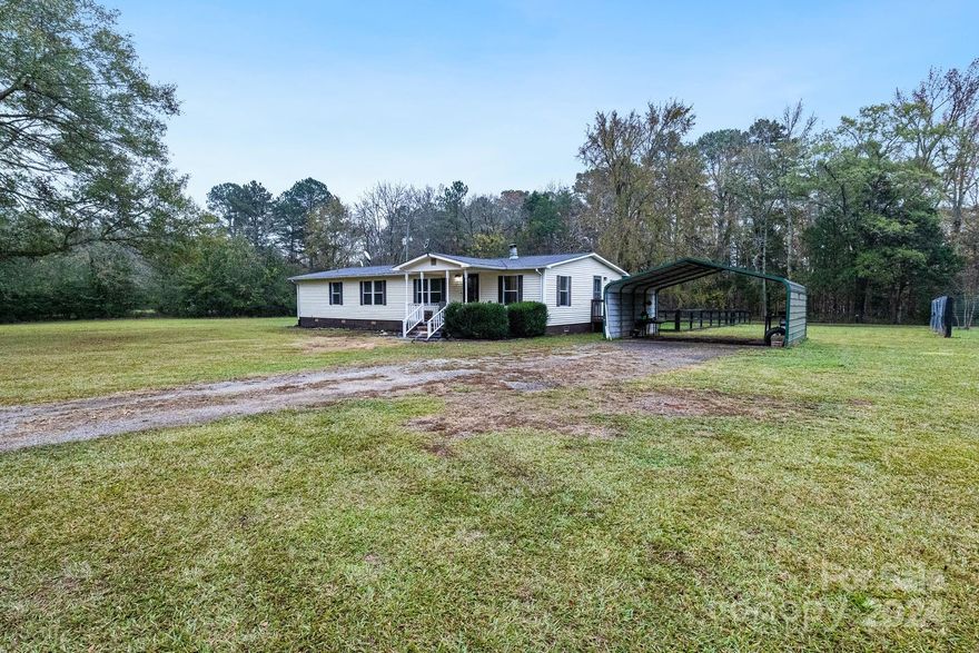 Enjoy country living in this charming home in Rock Hill. With 3 bedrooms and 2 bathrooms, this home offers a cozy and functional layout. The kitchen is perfect for meal prep, and the spacious living area provides a great place to unwind. Outside, you'll find a large rear deck, a 2-car carport, and a storage building—all situated on 5 acres of peaceful land. Located just a short drive from downtown Rock Hill, this home offers the perfect blend of privacy and convenience.
