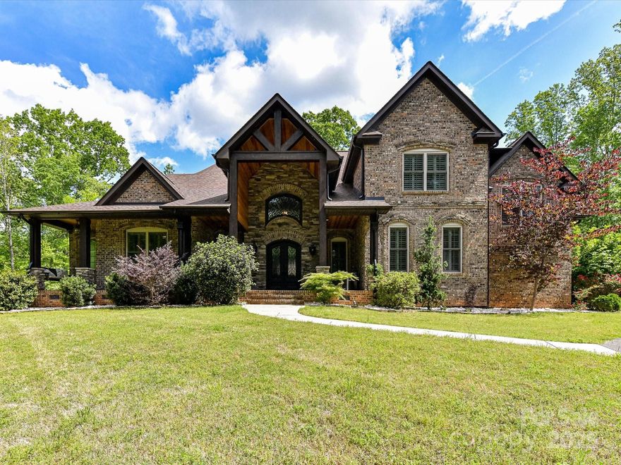 Gorgeous Full Brick & Stone, 2 story home w/ walk out basement overlooking pool on 6.5 acres of private wooded sanctuary within minutes of Fort Mill's dining & shopping! Stunning stacked stone front entrance & Great Room features hardwood floors, large picture windows & stacked stone fireplace! Beautiful Kitchen custom cabinets & granite features built in Wolf gas range, wall oven, warming drawer, 2 dishwashers, pot filler & wine fridge with marble flooring & stone accent wall in the dining area! Primary on main w/ trey ceiling, luxury bathroom w/ soaker tub & private tiled shower! Upstairs you'll find 2 large bdrms + bonus room/4th bed w/ New carpet! Basement features New '24 LVP plank flooring throughout & a second kitchen w/ bar seating perfect for entertaining! Plus guest bedroom & exercise/flex room! Huge deck & screened in porch! Room to build 2nd living quarters or workshop at front entrance! You'll love the acres of trees and views of sugar creek behind the property! Must See!