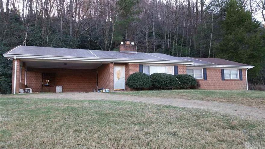 Brick ranch on full, unfinished basement less than 10 minute drive to Boone. Close to Blue Ridge Parkway, Rocky Knob Bike Park, Appalachian State University, county soccer complex. Some remodeling has been done in the past. Updated kitchen. Rock fireplace and hardwood floors in the dining area/den. Large yard - 1.5 acre lot is partially wooded. Spacious carport. Unfinished basement is in poor condition.  Foreclosure.