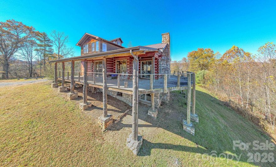 Located just a few minutes from Marshall on a hilltop overlooking the mountains beyond, this is an idyllic hideaway for anyone seeking privacy yet convenience for a large family, friends or homestead.  The Mountain House offers four bedrooms and has been operated as a STR.  This is a high-end log home on a high knoll with views in all directions with soaring great room and large gourmet kitchen complimented by a wrap around covered deck on three sides.  Three bedrooms, den and bath in the lower level with the upper level comprising the entire Primary Suite.  Plenty of room for parking or additional structures.  Detached small garage/workshop is ideal for storing an off road side-by-side.  Large flat graded area below the house could be another house site or additional parking.  Plenty of gently laying and flat grassy area around the house for outside play and activities.  Only qualified buyers please.  Must provide proof of funds prior to showing and at least 48 hours notice.  Property is surveyed and will need a dedicated easement for access to the paved road.  This property is also listed as part of a larger offering that includes 49.3 more acres and another large multipurpose building.  See MLS 4317608 SFR for pricing if sold together.