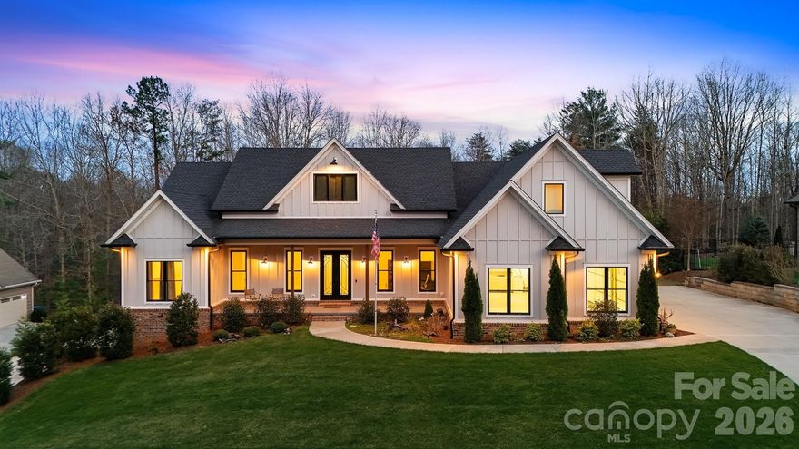 This stunning custom-built 2021 modern farmhouse offers 5,294 finished heated square feet of luxurious, thoughtfully designed living space in the highly desirable River Bend neighborhood. Perfectly situated in the Lake Hickory / Granite Falls area, this home provides convenient central access near US-321 and I-40.
The main level features an effortless open-concept layout ideal for entertaining, seamlessly blending the gourmet kitchen, dining area, and living room anchored by a cozy gas log fireplace. The chef's kitchen impresses with quartzite countertops, an oversized island, under-cabinet lighting, a walk-in pantry, premium stainless-steel appliances, a Thor gas range with an exquisite custom range hood, and a dedicated beverage refrigerator. Two bedroom ensuites grace the main level for ultimate convenience, complemented by a private office, ambient lighting throughout, and an additional bedroom ensuite on the upper level. 4 total bedrooms plus 5.5 bathrooms, in total.
The living room opens to your private oasis: a gas-heated saltwater pool and jacuzzi, enhanced by exterior lighting, surround sound, and a full irrigation system.
The fully finished basement expands your living options with a spacious recreation/media room, an additional bedroom, 2 full bathrooms, a future kitchen rough-in, a bonus room all accessible by a private entrance, and a one-bay garage.
Practical luxury abounds with a main-level side-entry three-bay garage, Generac whole-house gas generator, central vacuum, whole-house de-humidifier, radon mitigation, hard-wired camera system, LiftMaster MyQ garage doors, hardwired Eero Mesh Internet, RV receptacle, and spray foam insulation throughout.
This rare combination of modern elegance, thoughtful amenities, and prime location makes this home an exceptional opportunity near Lake Hickory.