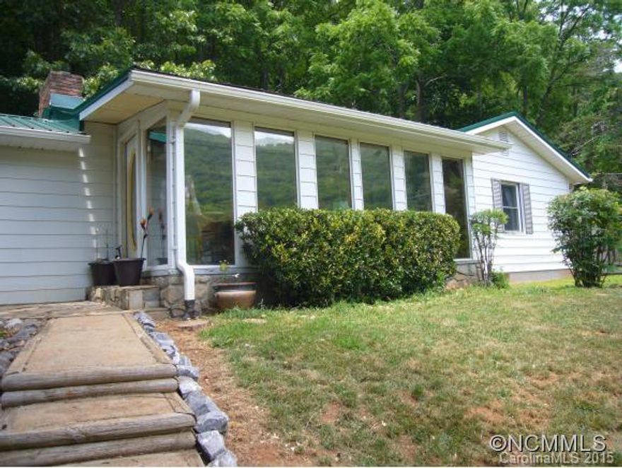 MOUNTAIN VIEWS FROM THIS PRIVATE ONE LEVEL HOME WITH FIREPLACE. 3/2 WITH IN GROUND SWIMMING POOL, GAZEBO, CREEK, PASTURE, OUTBUILDINGS, NEW METAL ROOF AND NEWER VINYL WINDOWS, AND AN INVISIBLE FENCE. GREAT YEAR ROUND OR VACATION HOME. ENJOY THE VIEWS FROM SUNROOM OR RELAX ON LARGE COVERED PATIO. MINUTES FROM VA HOSPITAL, AND DOWNTOWN ASHEVILLE.