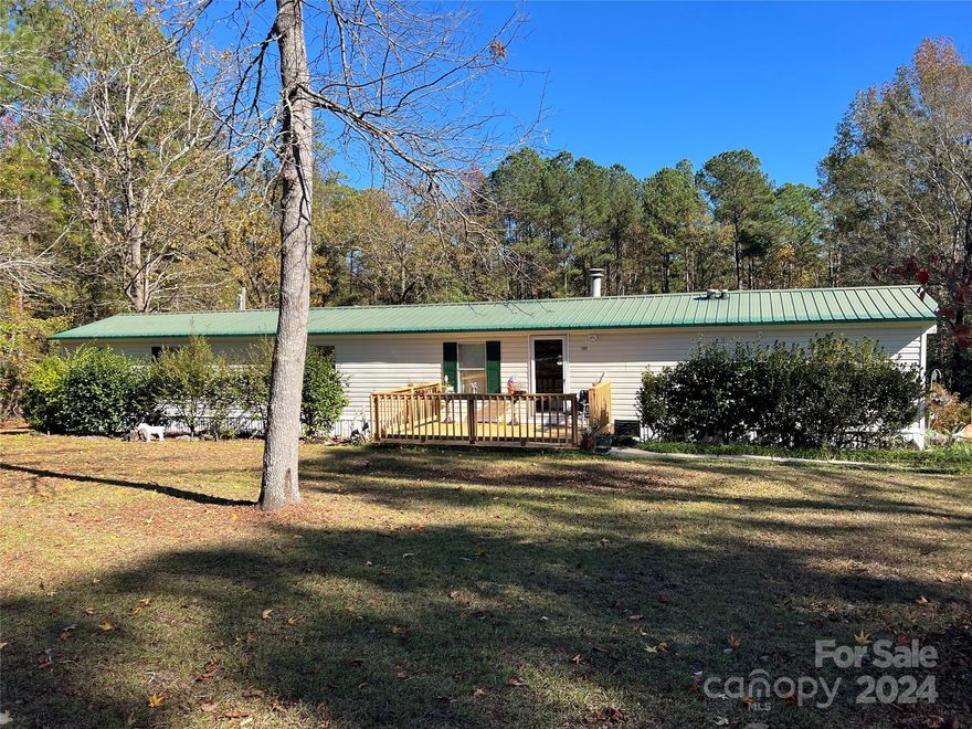 Country Retreat with Ample Outdoor Amenities! Welcome to this delightful 3-bed, 2-full bath home, with 1,242 sqft of living space. Nestled on 1.3 acres - a serene escape with beautiful blueberry bushes, flowering plants, & mature trees. New electric water heater & central heat/air (2023), Low-maintenance metal roof, all appliances convey, plus a 21 cu ft upright freezer in the workshop. Multiple Outbuildings also convey - a workshop, perfect for your hobbies, a shed for canning fruits, a metal carport for 2 vehicles, 2nd metal carport for equipment storage, and additional outbuildings for flexible storage needs. County water for indoor convenience & well water for outdoor use, or switch to the well for household water, if preferred. This property offers modern updates along with the charm of the area! Don’t miss your chance to own this unique property! Schedule your showing today & start enjoying the peace & possibilities this home has to offer!