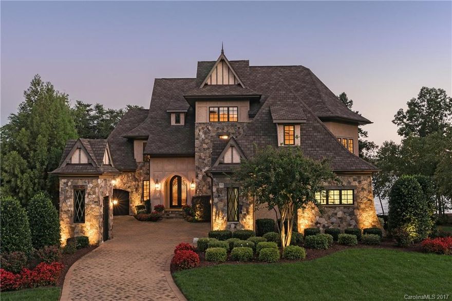 Extraordinary waterfront setting with Lake Norman sunset views & 180+/- feet of shoreline. Tom Stevenson luxury appointments include cast iron entry doors, Travertine, marble, warm hardwoods, custom cabinetry, extensive millwork & stone accents throughout. Exquisite kitchen with keeping room & spacious owner's suite has morning  kitchen. Lake level rec room, wine cellar/tasting room & guest suite. Verandas extend to the resort pool/spa for fabulous entertaining & lakeside al fresco dining.